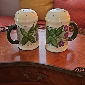 Vintage ceramic salt and pepper shakers with green and blue flowers.